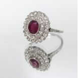 An 18ct ruby and diamond cluster ring, size N.