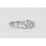 A fine single stone diamond ring with four baguette cut diamonds to the shoulders, clarity VS1,