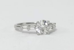 A fine single stone diamond ring with four baguette cut diamonds to the shoulders, clarity VS1,