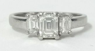 A platinum three stone diamond ring, set with three baguette cut diamonds, with the centre diamond