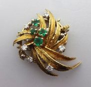An 18ct spray brooch set with six diamonds and four emeralds, 8.2gms.