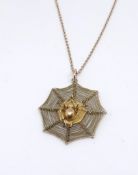 A 14ct spiders web pendant and chain, 5.70gms.