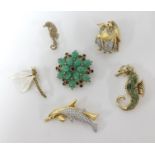 A collection of six brooches including a 9ct gold seahorse.