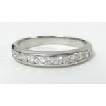 Tiffany & Co, a platinum and channel set diamond half band eternity ring, size U/V, marked '