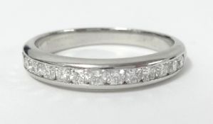 Tiffany & Co, a platinum and channel set diamond half band eternity ring, size U/V, marked '