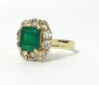 An 18ct emerald and diamond cluster ring, marked '18k', size Q.