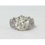 An impressive art deco style platinum and diamond ring, the centre stone weighing approx 4ct further