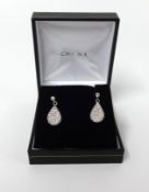 A pair of diamond pave set drop earrings.