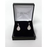 A pair of diamond pave set drop earrings.