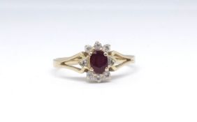 An 18ct ruby and diamond cluster ring, size O.