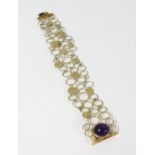 An 18ct amethyst set gold buckle, length 20cm, width 3cm.