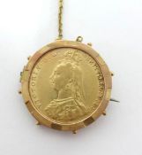 An 1887 Victorian full sovereign in a gold mount.