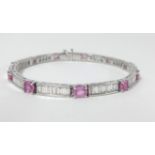 An 18ct white gold diamond and pink sapphire bracelet, length 20cm.