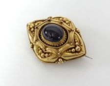 A Victorian garnet gold brooch.