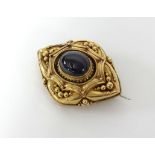 A Victorian garnet gold brooch.