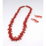 A coral necklace and similar earrings.