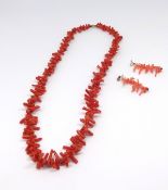 A coral necklace and similar earrings.