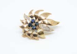 A 9ct sapphire and diamond set sunburst brooch, 5.80gms.