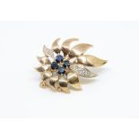 A 9ct sapphire and diamond set sunburst brooch, 5.80gms.