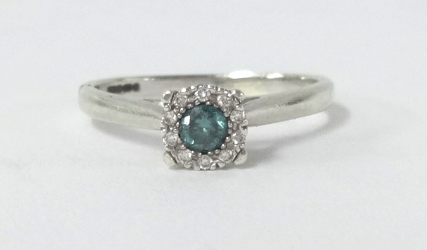 A 9ct white gold blue diamond cluster ring, size L.