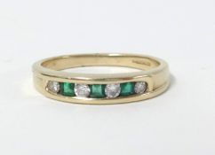 A 14ct emerald and diamond set ring set and channel set with round cut and princess cut diamonds and