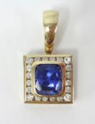 An 18ct gold tanzanite and diamond pendant, the cushion cut tanzanite approx 6.60ct, with 20 round