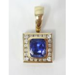 An 18ct gold tanzanite and diamond pendant, the cushion cut tanzanite approx 6.60ct, with 20 round