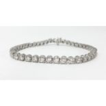 A platinum and diamond set line bracelet, total diamond weight approx 5ct, set with 45 diamonds