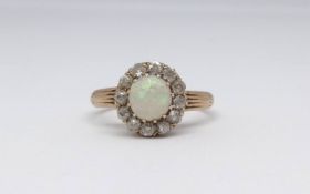 An 18ct opal and diamond cluster ring, size N.