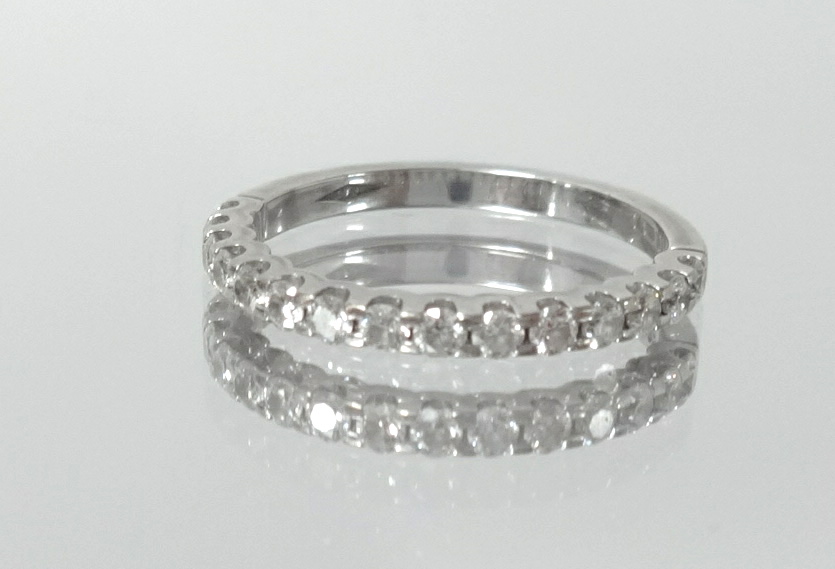 An 18ct white gold and diamond set half band eternity ring, size L.