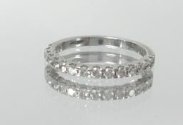 An 18ct white gold and diamond set half band eternity ring, size L.