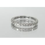 An 18ct white gold and diamond set half band eternity ring, size L.