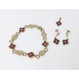 A 9ct gold suite of jewellery consisting of ruby and diamond flower cluster formation bracelet