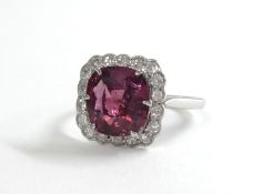 An 18ct diamond and tourmaline ring, size Q.