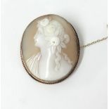 A yellow metal set cameo brooch with a portrait of a lady.