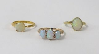 Three opal set rings including 18ct.
