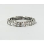 A diamond full band eternity ring set in white gold, size L.