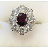 A good 18ct ruby and diamond cluster ring with central ruby stone and eight surrounding