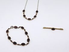 A group of 9ct garnet set jewellery comprising a brooch, a bracelet and a necklace (3).