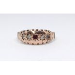 An antique 9ct rose gold ruby and diamond ring, size O.