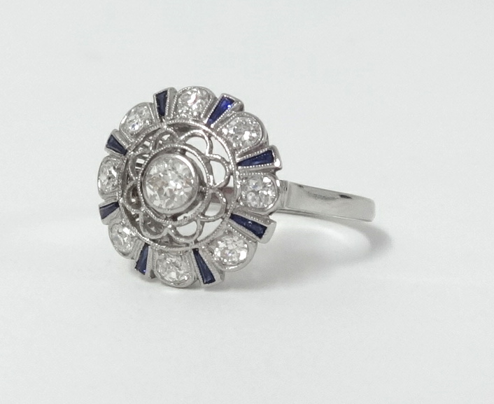 A diamond and sapphire cluster ring set in white gold?, size N.