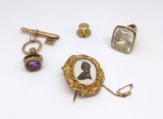 An antique amethyst set seal, a large clear glass seal with portrait, a single stud and a 19th