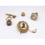 An antique amethyst set seal, a large clear glass seal with portrait, a single stud and a 19th