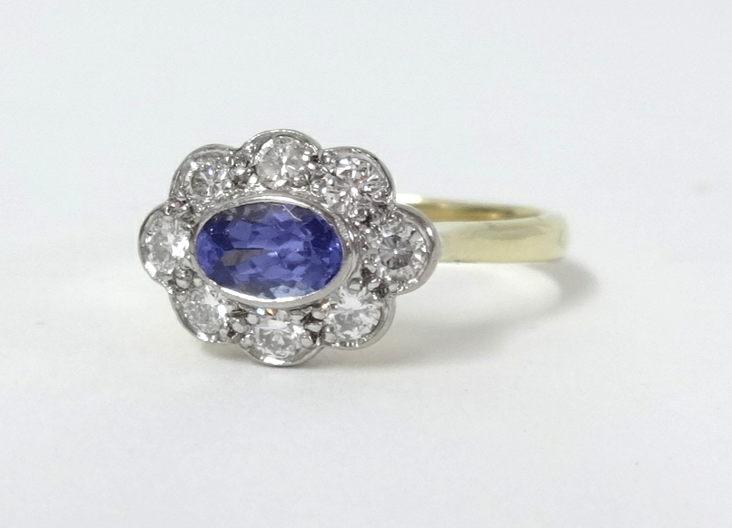 An 18ct tanzanite and diamond cluster ring, size N.