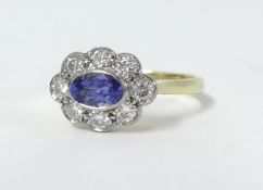 An 18ct tanzanite and diamond cluster ring, size N.