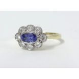 An 18ct tanzanite and diamond cluster ring, size N.