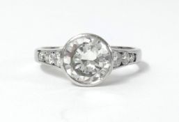 An 18ct white gold diamond ring the centre stone approx 2.80ct, further set with three round cut