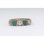 An 18ct turquoise and diamond five stone ring, size P.