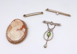 A 9ct cameo brooch, a 15ct pearl bar brooch, a 9ct bar brooch and an antique peridot and enamelled