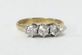 An 18ct three stone diamond ring, size M.